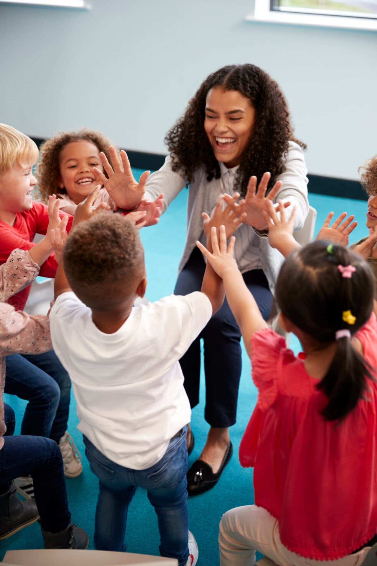 A Little People’s Landing teacher reading with children
